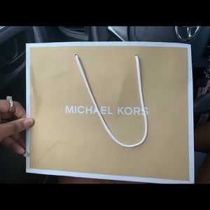 Michael Kors brown shopping bag.